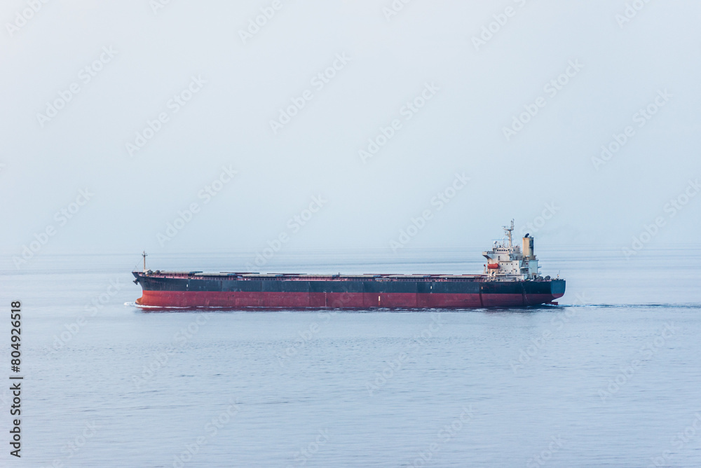 Cargo ship, bulk carrier sailing through the calm sea.