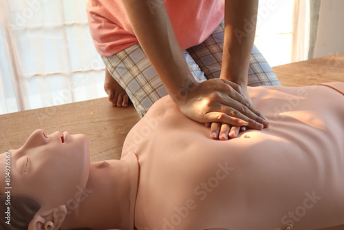 Close-up of CPR on doll's hand (Cardiopulmonary Resuscitation) A resuscitation technique used in emergencies to resuscitate a person who has stopped breathing or whose heart has stopped beating. photo