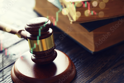 Wooden judge gavel and legal book on wooden table photo