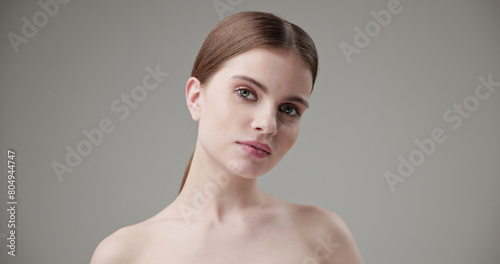 Beauty, health, cosmetics, anti-aging therapy and skin care concept - young beautiful brunette Caucasian woman posing and looking at the camera with a calm confident look © Anatoly Repin