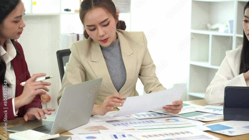 Business meeting of young Asian women with laptops and documents together to discuss project financial reports Company business collaboration concept Business meeting of young Asian women with laptops and documents together to discuss project financial reports Company business collaboration concept
