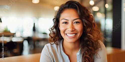 smiling woman with curly hair in cafe