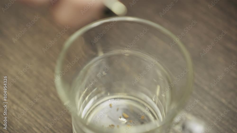 Instant coffee granules are poured into a glass cup. Top view. Slow motion Instant coffee granules are poured into a glass cup. Top view. Slow motion