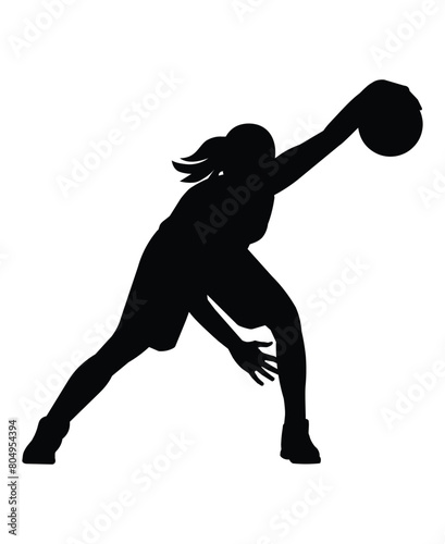 Silhouette of a women's basketball girl player who stand with the ball in her hand and performs a crossover jab