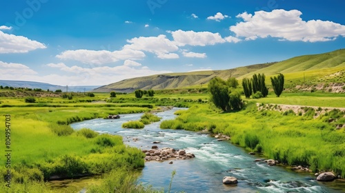 Scenic landscape with a flowing river and lush green hills