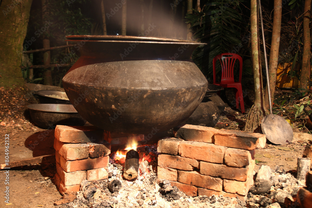 overnight cooking in a village party on a temporary brick made oven. Outdoor cooking for lots of people in large aluminum pan in wood fire. huge cooking at village in Bangladesh. overnight cooking in a village party on a temporary brick made oven. Outdoor cooking for lots of people in large aluminum pan in wood fire. huge cooking at village in Bangladesh.