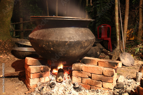 overnight cooking in a village party on a temporary brick made oven. Outdoor cooking for lots of people in large aluminum pan in wood fire. huge cooking at village in Bangladesh. photo