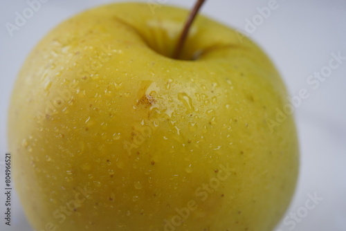 Perfect Fresh Yellow Apple Isolated on White Background with water drops. Fresh fruits.