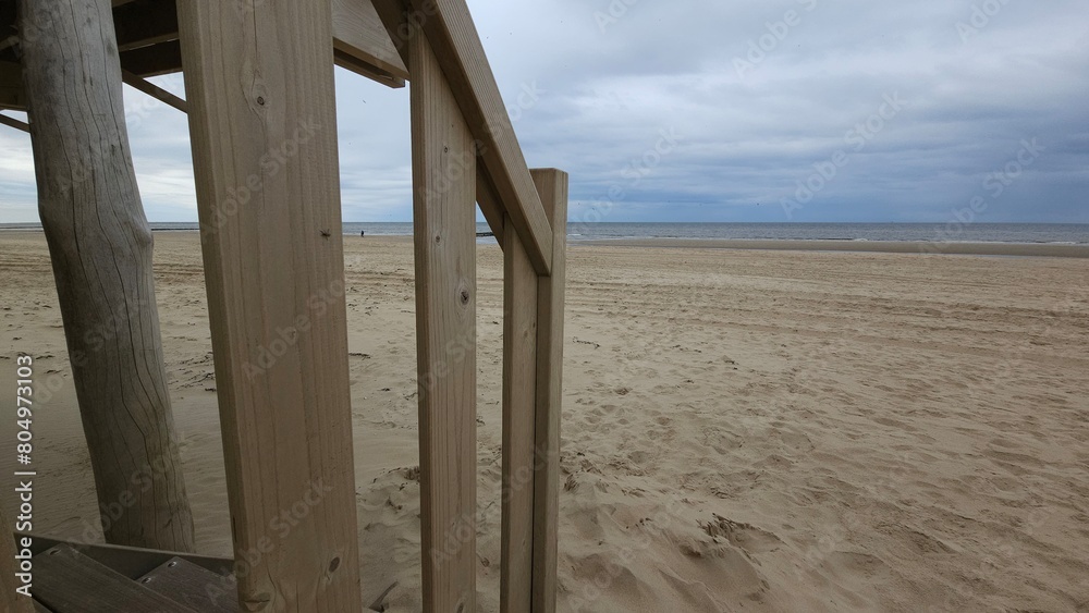 Fototapeta premium Blick auf den Strand, Nordsee, mit Treppe und Treppengeländer eines Strandhauses