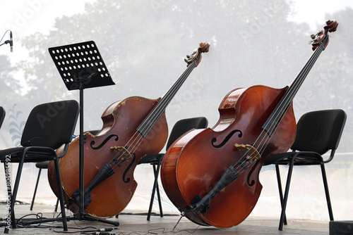 2 two Double bass standing on stage. Big bass viol on the scene before the concert. before the musicians event performance scene. Contrabass on stage in front of an empty hall