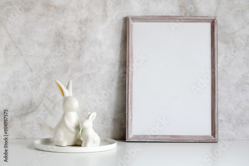 Easter mockup. empty wooden frame and rabbit figurines. background, an empty space for your text or object. creator of the scene.