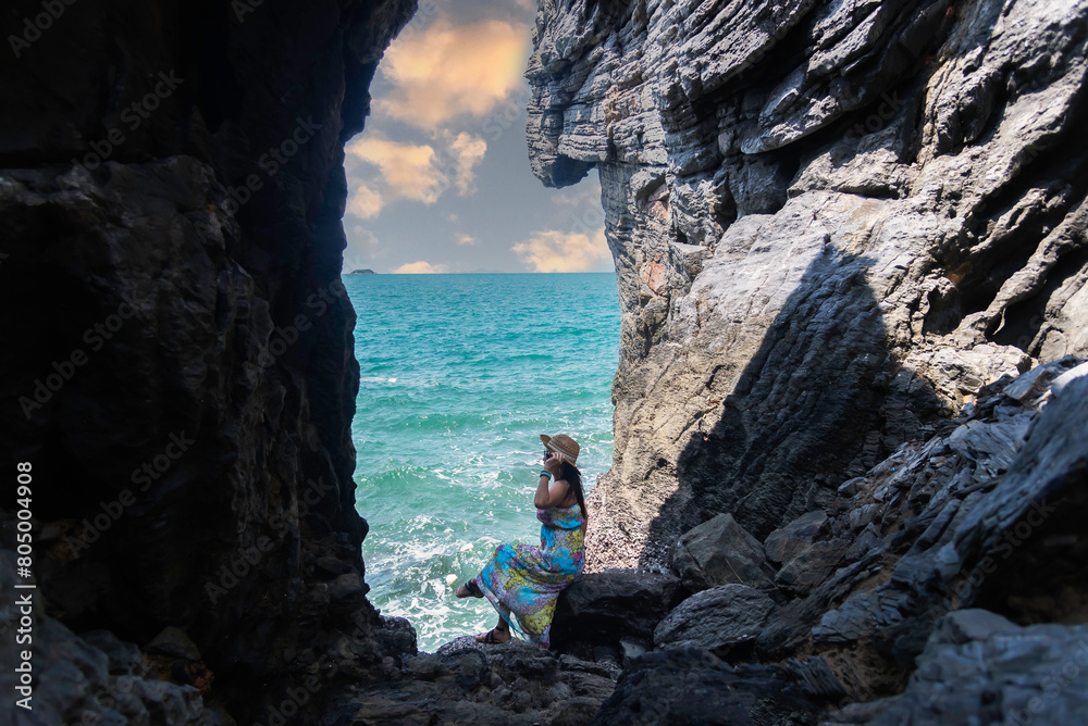 Travel people women tourist adventure in a cave near the sea. Travel Concept. Travel people women tourist adventure in a cave near the sea. Travel Concept.