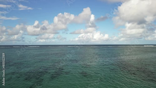 Waves that break on the reef on the coast of the island of Mauritius and slowly run out towards the island.