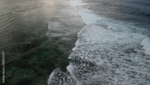 Waves that break on the reef on the coast of the island of Mauritius and slowly run out towards the island.