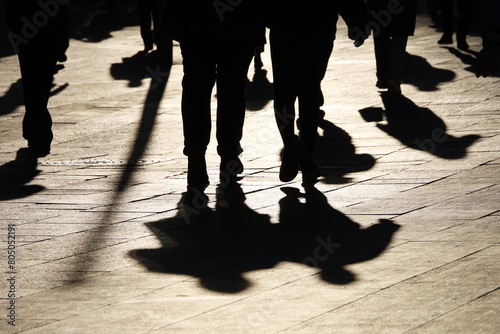 Фотография Black silhouettes and shadows of people on the street