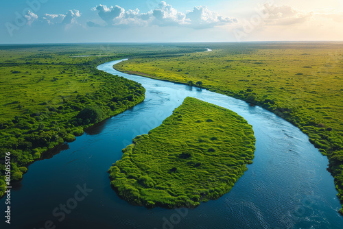 Drone shot of a river winding through a lush green landscape, reflecting the sky. AI generated. photo