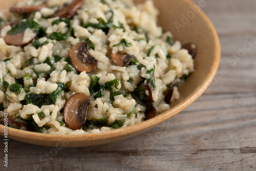 Close up view of homemade lemon risotto with spinach and portobello mushroom. Healthy lifestyle concpt. photo