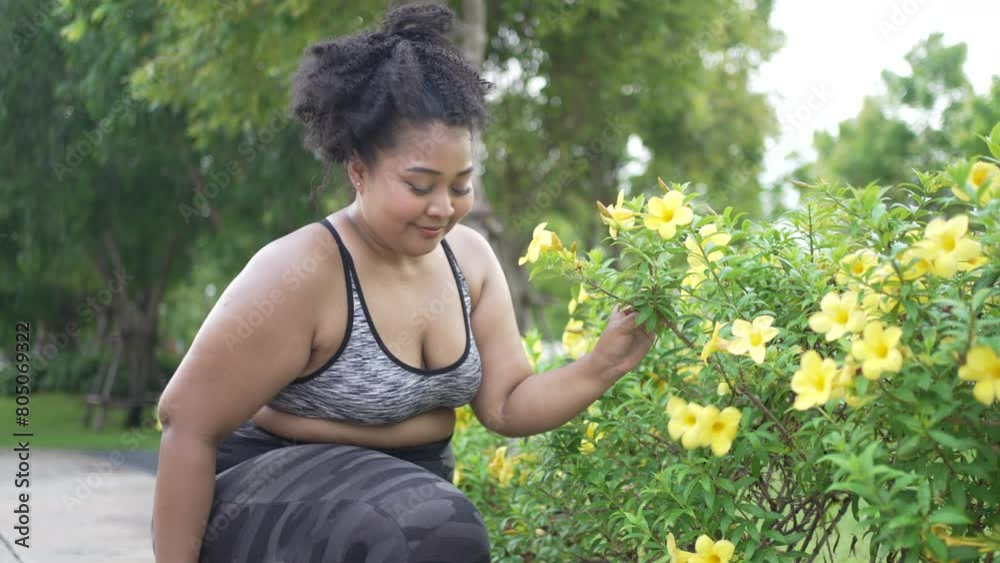 chubby woman is using smart phone while workout at garden. chubby woman is using smart phone while workout at garden.