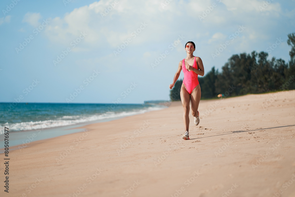 Healthy lifestyle. Jogging outdoors. Young woman exercising on sea beach.