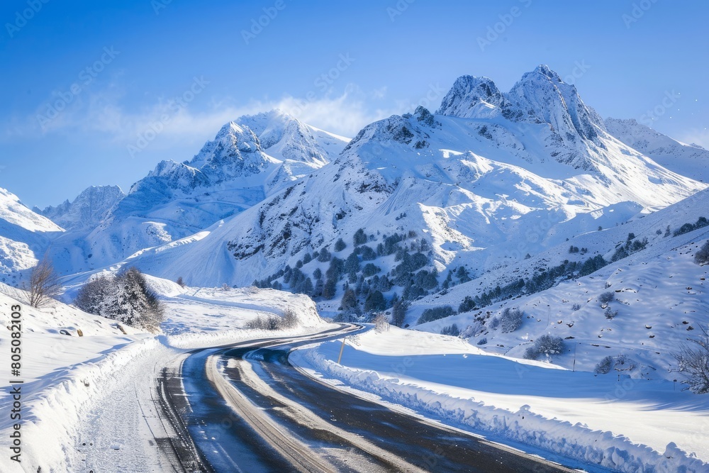 Serene winter scene of a mountain road winding Serene winter scene of a mountain road winding