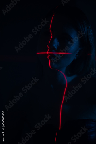 Shine a red laser in the shape of a cross at the girl. Future and virtual reality concept