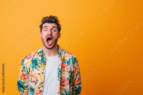 Georgian adult male in stylish clothing with wide open eyes on one-color background photo