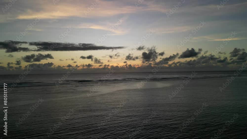 A timelapse drone shot of the sunrise of the island of Mauritius with the sea and the magnificent clouds on the horizon and the rising sun A timelapse drone shot of the sunrise of the island of Mauritius with the sea and the magnificent clouds on the horizon and the rising sun