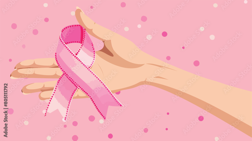 Human hand holds pink ribbon as a symbol of Breast ca
