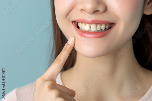Radiant Woman with a Bright Smile Pointing at Her Perfect Teeth  Designed for Oral Care Campaigns  Includes Space for Promotional Text.
