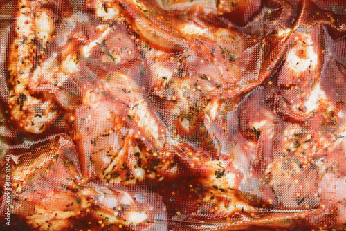 Vacuum sealing marinated meat. Meat covered with spices hermetic packaging. Plastic food roll for prolonged freshness.