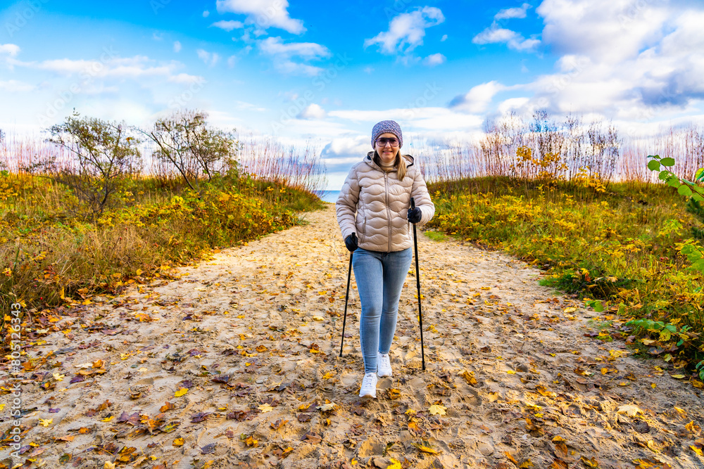 Nordic walking - beautiful woman exercising by the sea
Nordic walking - beautiful woman exercising by the sea