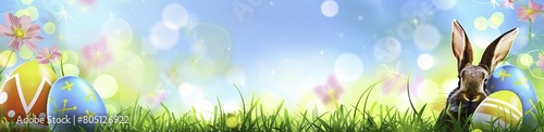 Easter Celebration: Colorful Eggs and Bunny Ears on Green Grass
