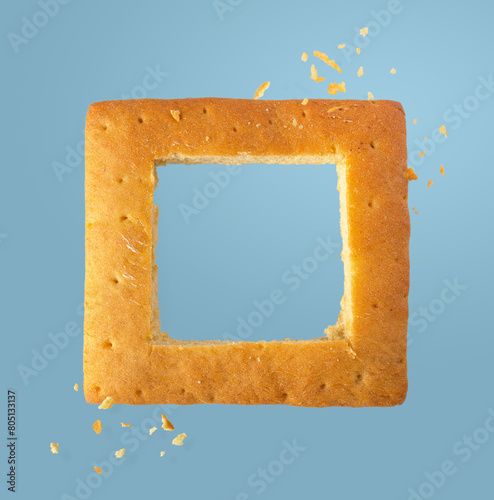 frame of white bread with crumbs on a blue background, copy space, flying food