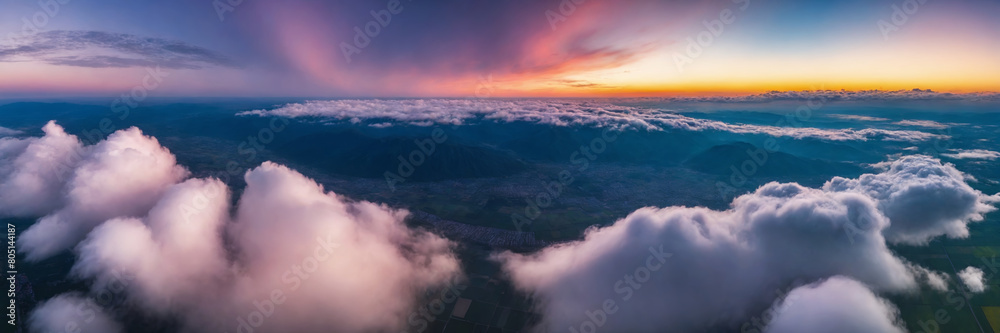 Fototapeta premium Aerial view of beautiful sunrise over the clouds. Panoramic image