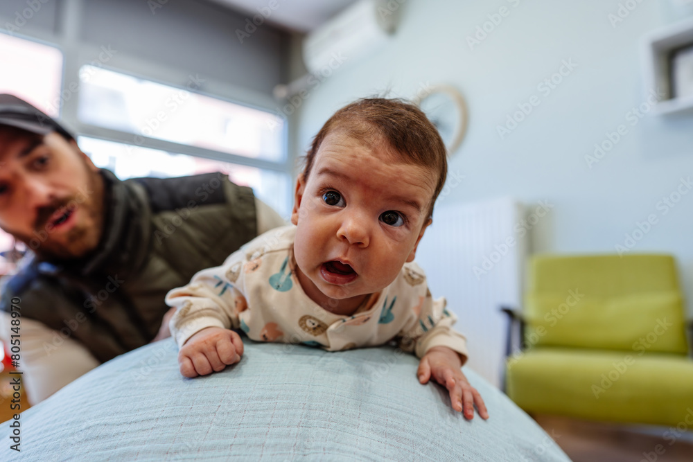 Adorable baby enjoys physical therapy sessions with a qualified therapist in a specialized children's gym or play area. Adorable baby enjoys physical therapy sessions with a qualified therapist in a specialized children's gym or play area.