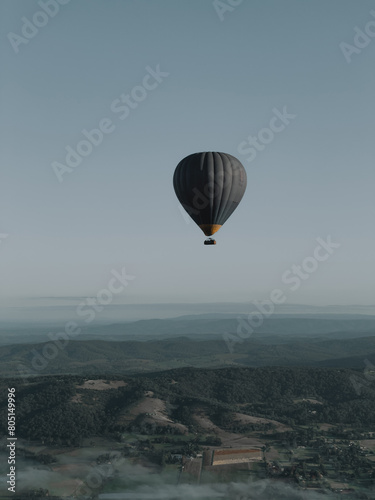 Black hot-air balloon flying over the mountain, awesome landscape view, Melbourne, Australia, Yarra Valley. Black and white photo © Alona Hrinchenko