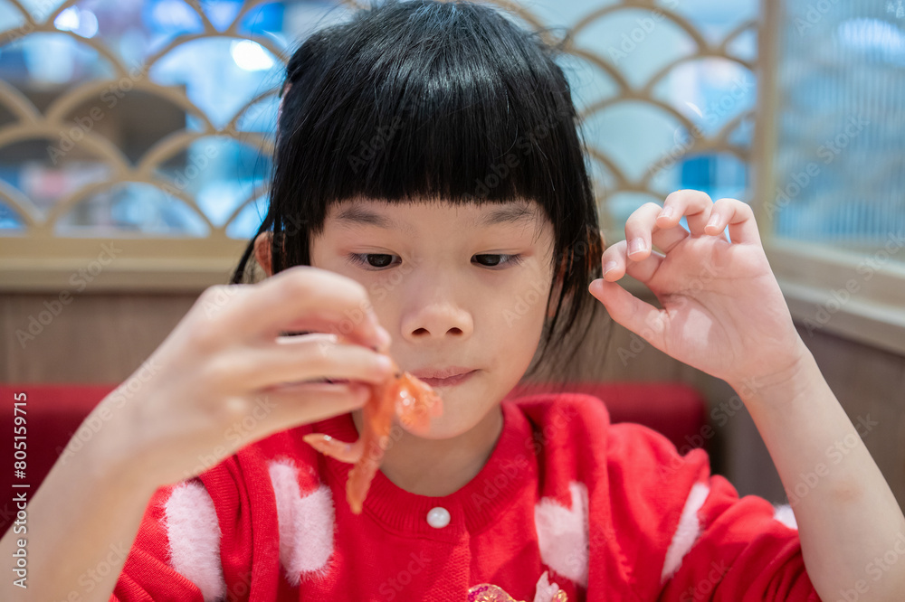 Cute little asian child girl eating food