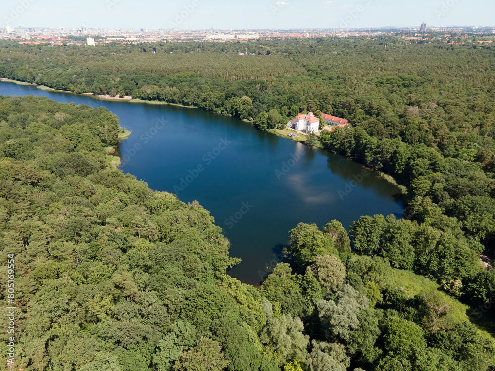 Aerial landscape of lake and Jagdschloss Grunewald in forest on a sunny summer day in Berlin