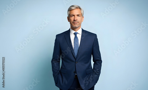 Close-up portrait of a middle-aged confident CEO boss businessman wearing a blue coat and professional formal outfit isolated from the background