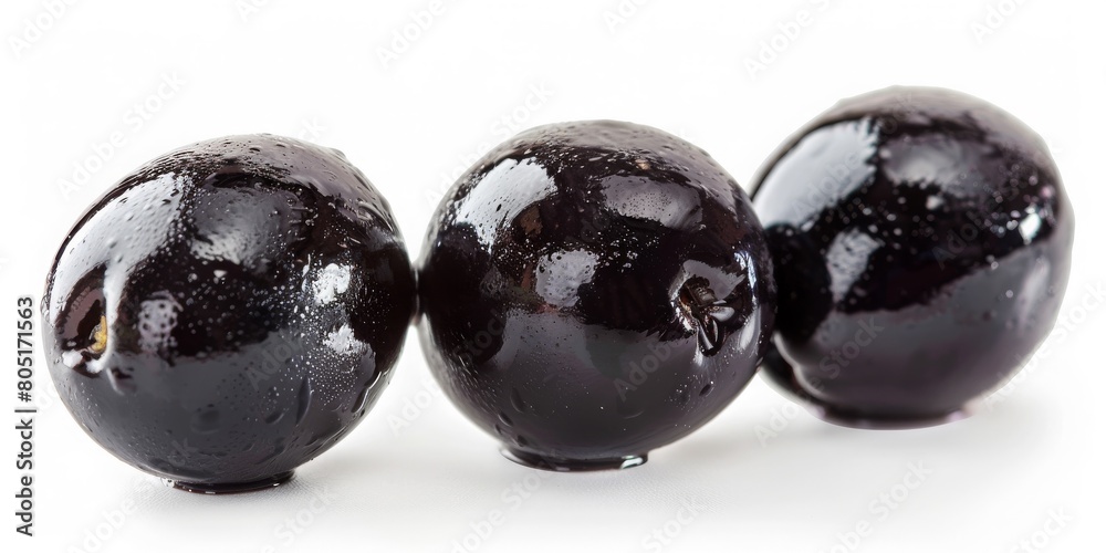 Three black olives are sitting on a white background Three black olives are sitting on a white background