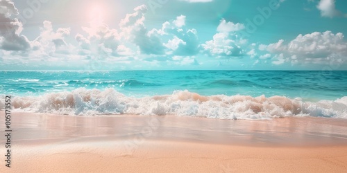 Beautiful natural tropical summer beach background with golden sand, turquoise ocean, and blue sky with white clouds.