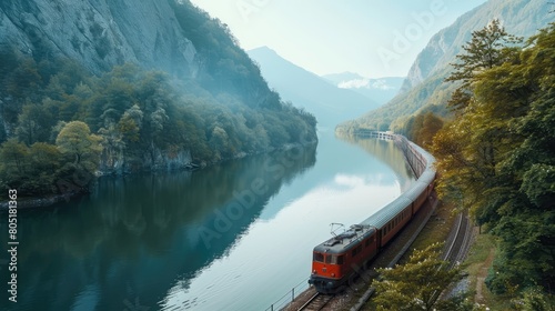 A train passing on a railway line beside a lake photo