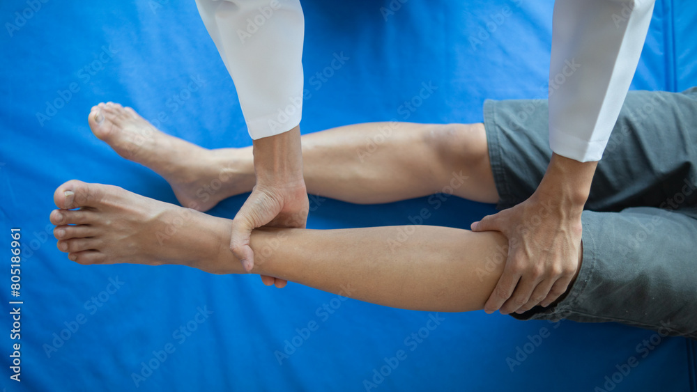 Doctors are examining patient muscle injuries and doing physical therapy for patient to move muscles so they can be used regularly because physical therapy will help strengthen muscles and blood flow.