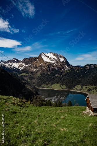Landsacpe view in the swiss apls with a mountain reflecting in a lake