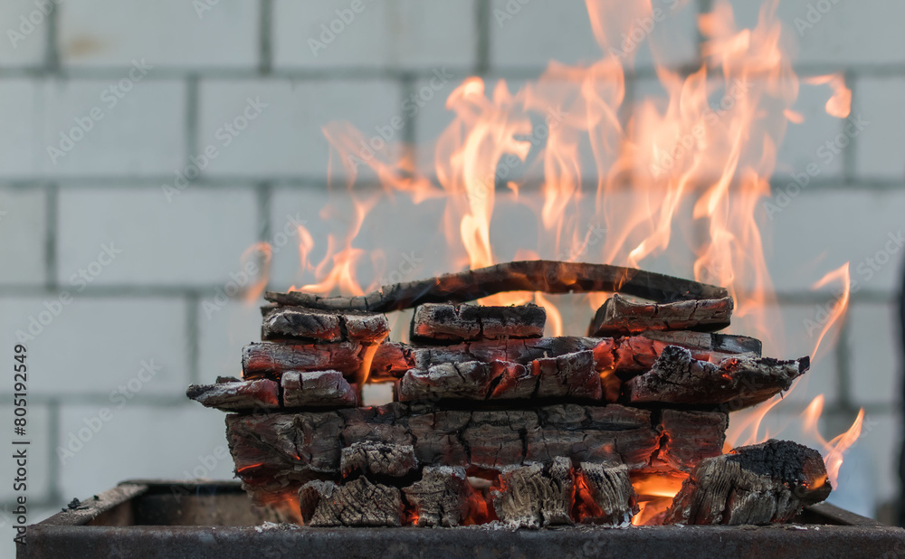 View of a campfire made of stacked logs View of a campfire made of stacked logs