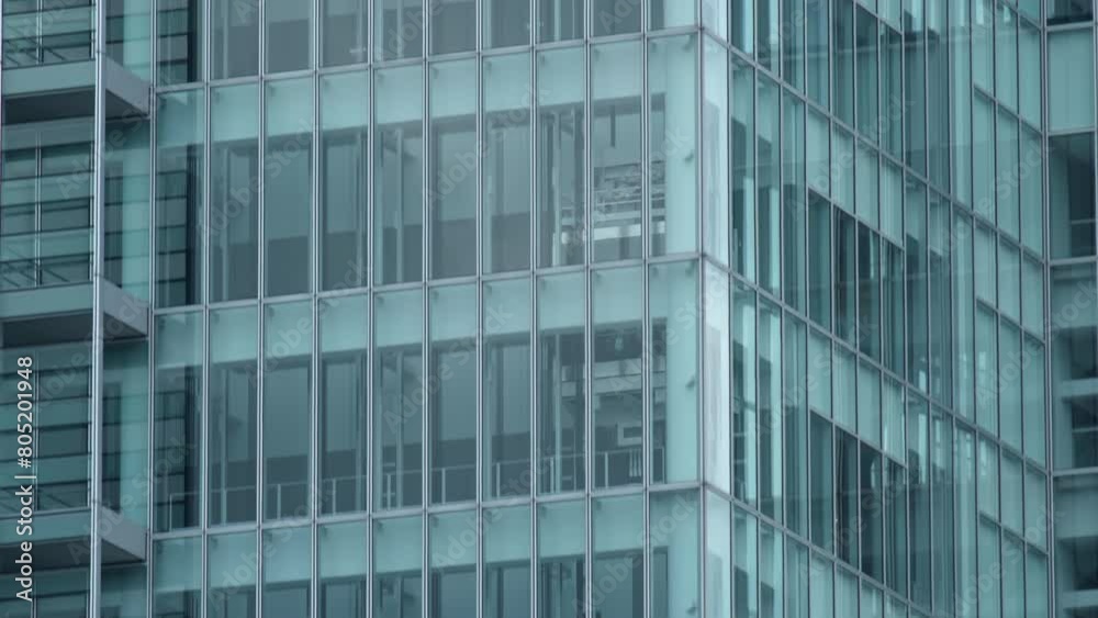 Glass elevators outside the skyscraper building, business architecture. Tilt shot. Glass elevators outside the skyscraper building, business architecture. Tilt shot.