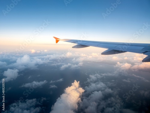 From the perspective of the high altitude aircraft's porthole, we can see the wings and clouds