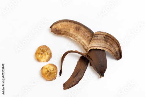 Banana and banana slices that have started to rot. Brown colored banana.