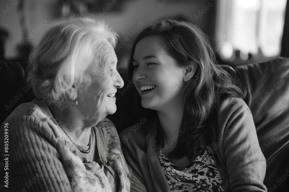 Black and white portrait of a happy family, adult granddaughter and grandmother on the sofa in a cozy bedroom, a charming photo captures the essence of family ties, portrait for Mother's Day Black and white portrait of a happy family, adult granddaughter and grandmother on the sofa in a cozy bedroom, a charming photo captures the essence of family ties, portrait for Mother's Day