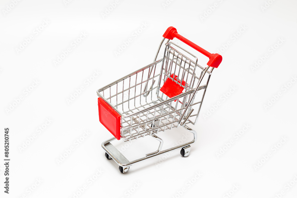 Toy shopping cart. Toy shopping trolley on white background. Toy shopping cart. Toy shopping trolley on white background.